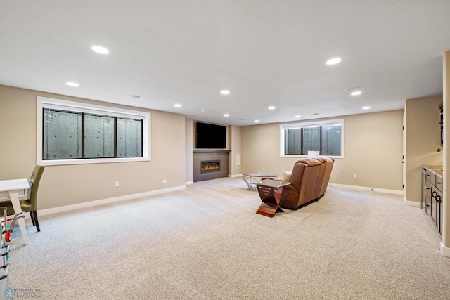 2704 1st St E, West Fargo, ND 58078 - living area with light colored carpet, recessed lighting, a warm lit fireplace, and baseboards