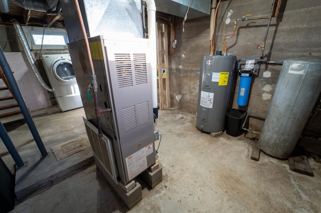 utility room with water heater, washer / dryer, and heating unit