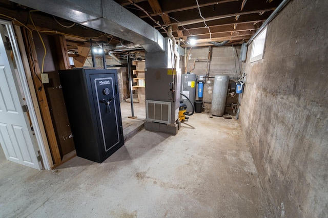 basement with heating unit and electric water heater