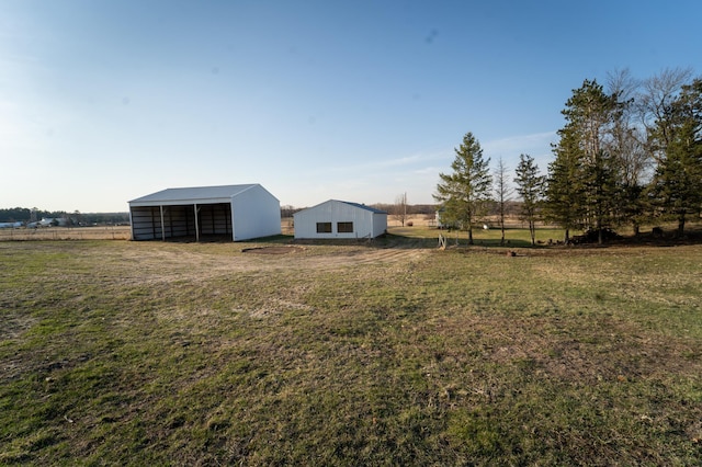view of yard with an outbuilding and fence