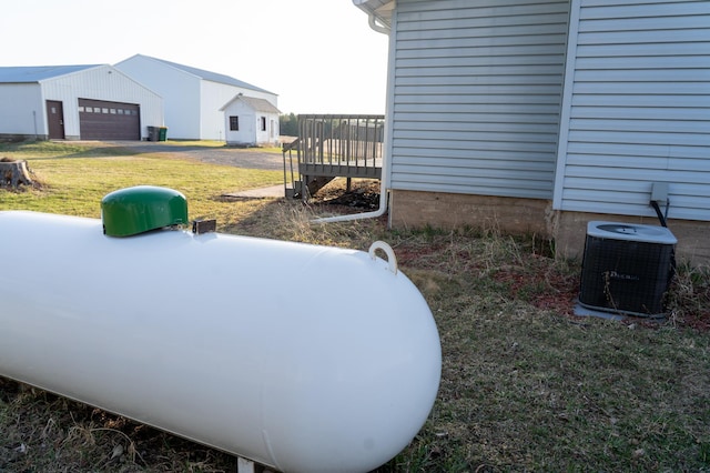 view of yard with central air condition unit and a deck