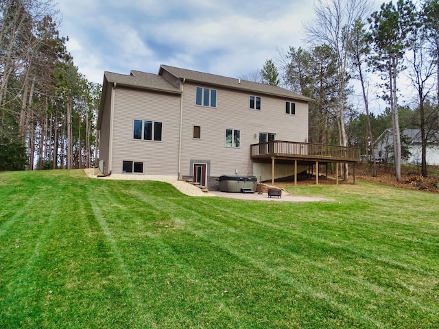 N1698 945th St, Rock Creek Twp, WI 54701 - back of house featuring a patio area, a wooden deck, a hot tub, and a yard