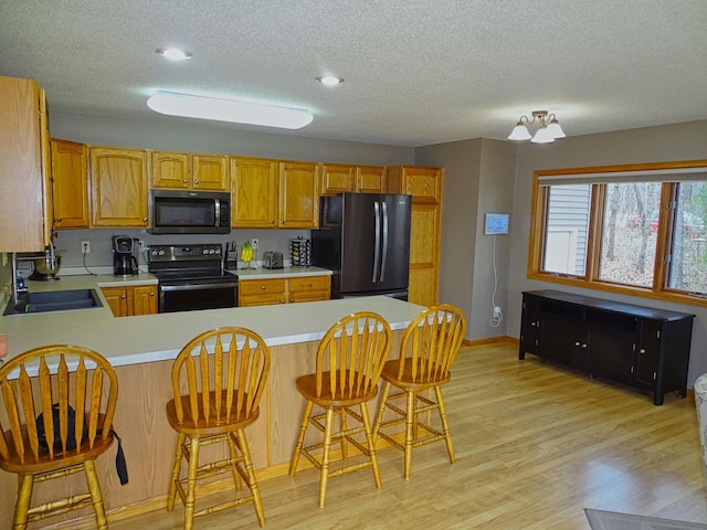N1698 945th St, Rock Creek Twp, WI 54701 - kitchen featuring black appliances, a sink, a textured ceiling, and light countertops