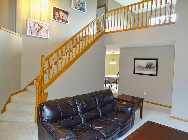 N1698 945th St, Rock Creek Twp, WI 54701 - carpeted living room featuring baseboards, a high ceiling, and stairs