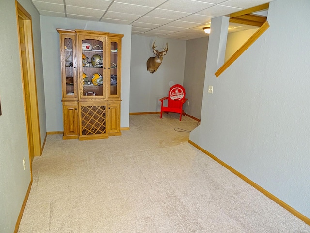 N1698 945th St, Rock Creek Twp, WI 54701 - recreation room with a paneled ceiling, baseboards, and light colored carpet