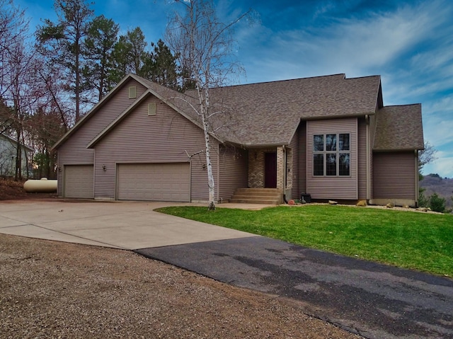 N1698 945th St, Rock Creek Twp, WI 54701 - view of front of home with a front lawn, driveway, roof with shingles, and a garage