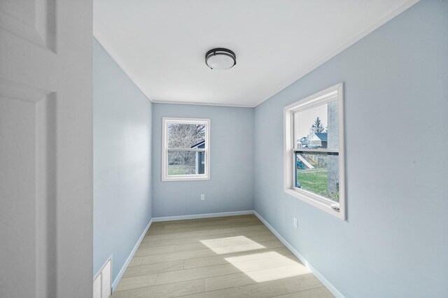 115 Prentice St, Clayton, WI 54004 - empty room featuring light wood-type flooring, visible vents, baseboards, and ornamental molding