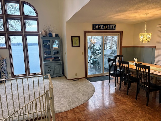 5060 Condons St SE, Prior Lake, MN 55372 - dining room featuring a chandelier, wainscoting, and a textured ceiling