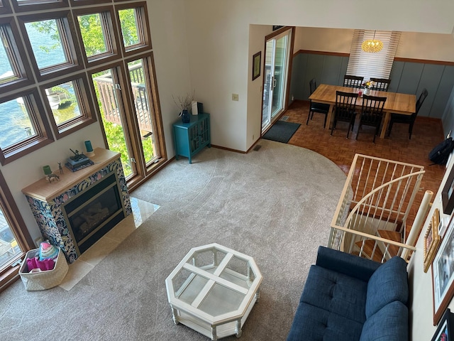 5060 Condons St SE, Prior Lake, MN 55372 - living room with carpet floors, a wainscoted wall, baseboards, and a chandelier