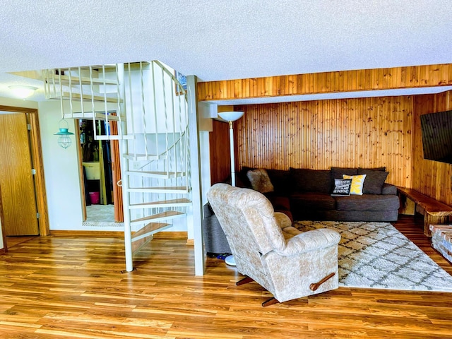 5060 Condons St SE, Prior Lake, MN 55372 - living area with wood finished floors, wooden walls, and a textured ceiling