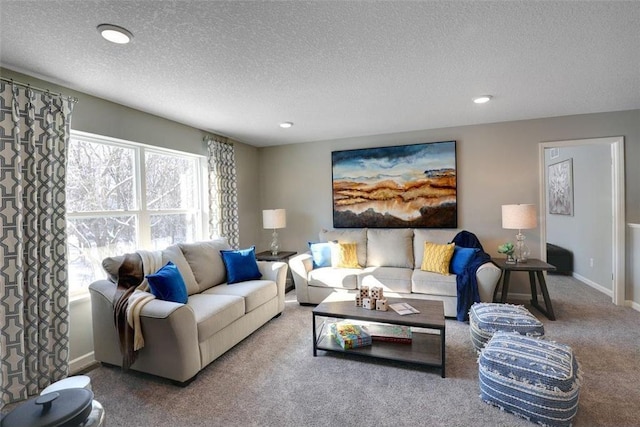 living room featuring carpet floors, recessed lighting, and a textured ceiling