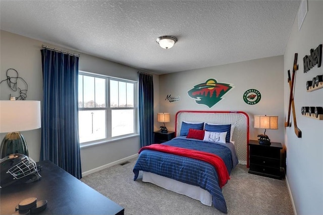 bedroom with visible vents, carpet, baseboards, and a textured ceiling