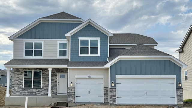 craftsman inspired home featuring a shingled roof and stone siding