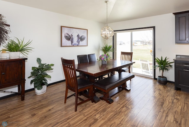 3497 50th St S, Fargo, ND 58104 - dining space with dark wood-style flooring, a chandelier, and baseboards