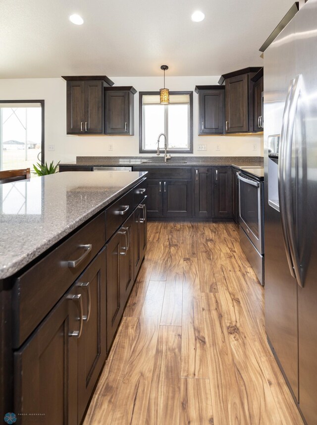 3497 50th St S, Fargo, ND 58104 - kitchen featuring appliances with stainless steel finishes, a sink, plenty of natural light, light wood-style floors, and recessed lighting