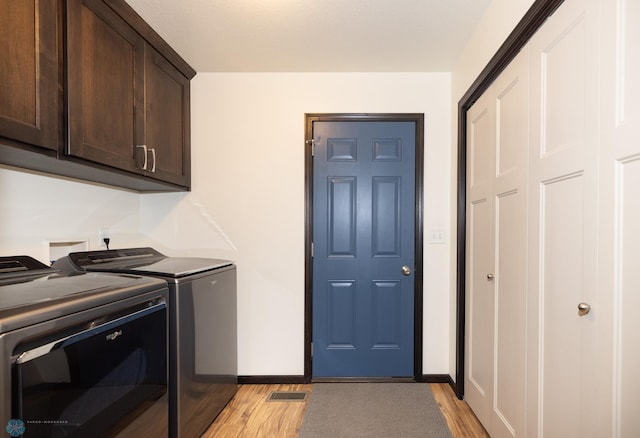 3497 50th St S, Fargo, ND 58104 - laundry area with washer and dryer, cabinet space, light wood-style flooring, and baseboards