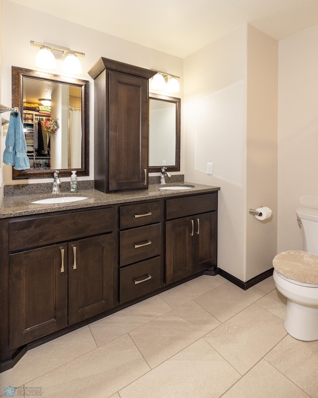 3497 50th St S, Fargo, ND 58104 - full bathroom featuring toilet, tile patterned flooring, double vanity, and baseboards
