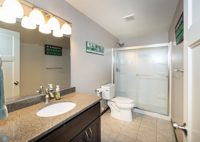 3497 50th St S, Fargo, ND 58104 - bathroom featuring a shower stall, tile patterned floors, toilet, vanity, and baseboards