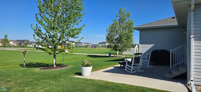3497 50th St S, Fargo, ND 58104 - view of grassy yard with a patio and a residential view