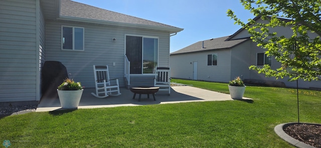 3497 50th St S, Fargo, ND 58104 - back of house featuring a patio, a yard, a shingled roof, and entry steps