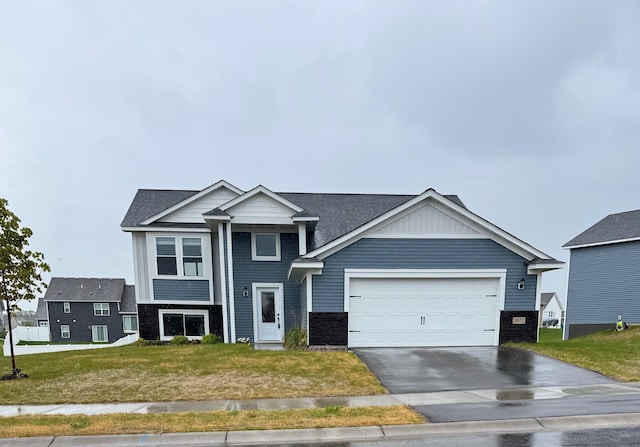 18872 Fillmore St NW, Elk River, MN 55330 - view of front facade with an attached garage, driveway, a front yard, a shingled roof, and stone siding