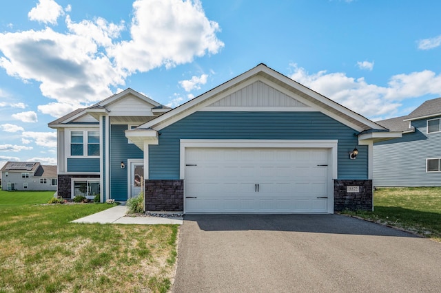 18872 Fillmore St NW, Elk River, MN 55330 - view of front facade with stone siding, driveway, an attached garage, and a front yard
