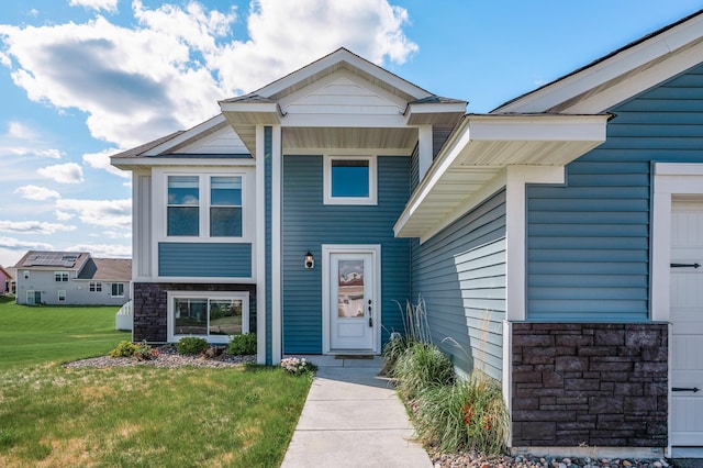 18872 Fillmore St NW, Elk River, MN 55330 - view of front facade featuring stone siding and a front yard