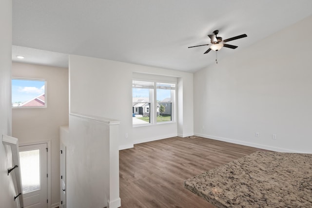 18872 Fillmore St NW, Elk River, MN 55330 - unfurnished living room with wood finished floors, ceiling fan, and baseboards