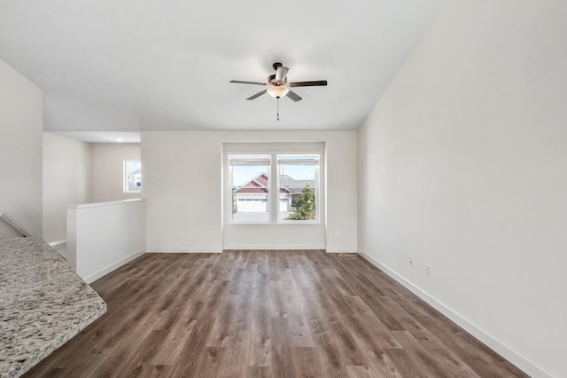 18872 Fillmore St NW, Elk River, MN 55330 - unfurnished living room featuring ceiling fan, wood finished floors, and baseboards