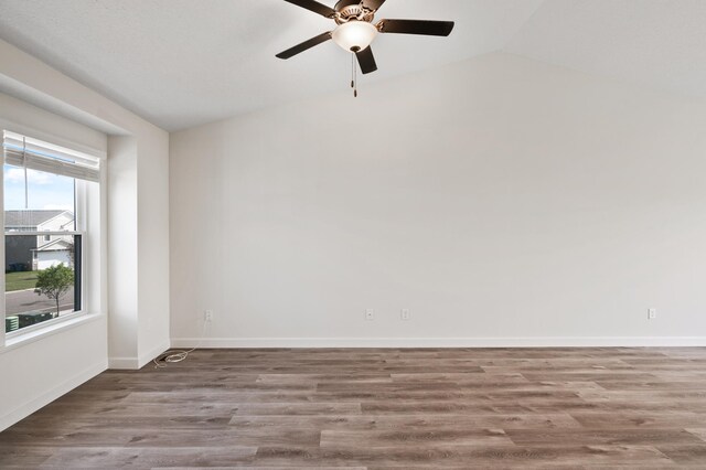 18872 Fillmore St NW, Elk River, MN 55330 - unfurnished room with wood finished floors, lofted ceiling, ceiling fan, and baseboards