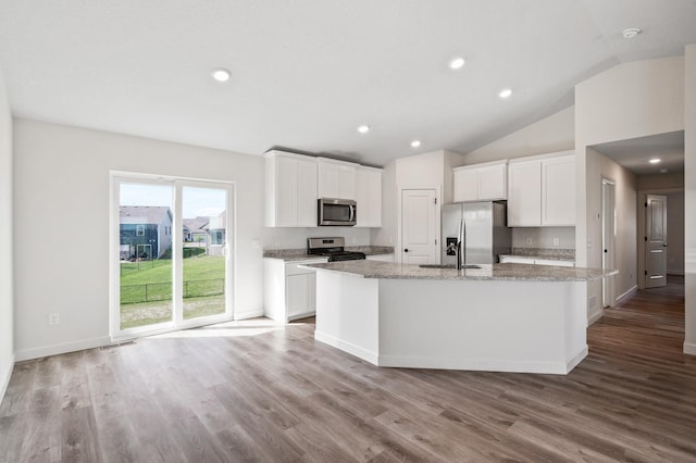 18872 Fillmore St NW, Elk River, MN 55330 - kitchen featuring stainless steel appliances, a kitchen island with sink, vaulted ceiling, white cabinetry, and wood finished floors