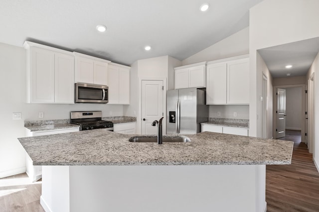 18872 Fillmore St NW, Elk River, MN 55330 - kitchen with stainless steel appliances, a sink, white cabinetry, an island with sink, and lofted ceiling
