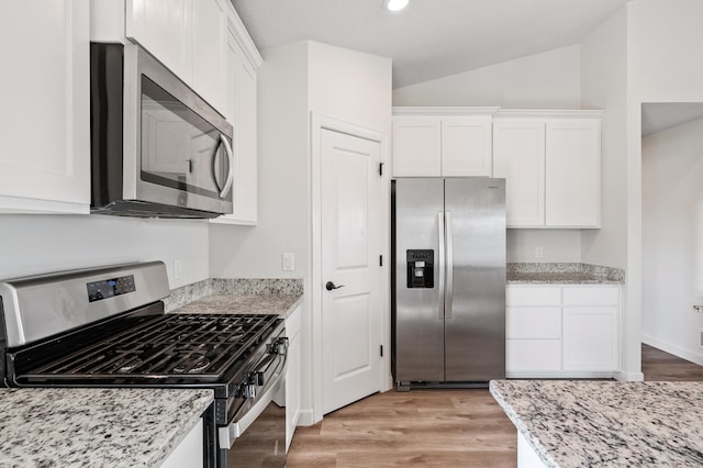 18872 Fillmore St NW, Elk River, MN 55330 - kitchen with appliances with stainless steel finishes, white cabinets, vaulted ceiling, light wood-type flooring, and light stone countertops
