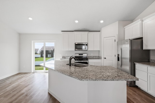18872 Fillmore St NW, Elk River, MN 55330 - kitchen featuring appliances with stainless steel finishes, a sink, dark wood finished floors, white cabinetry, and light stone counters