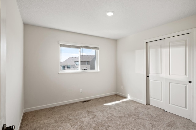 18872 Fillmore St NW, Elk River, MN 55330 - unfurnished bedroom with carpet flooring, a closet, and baseboards