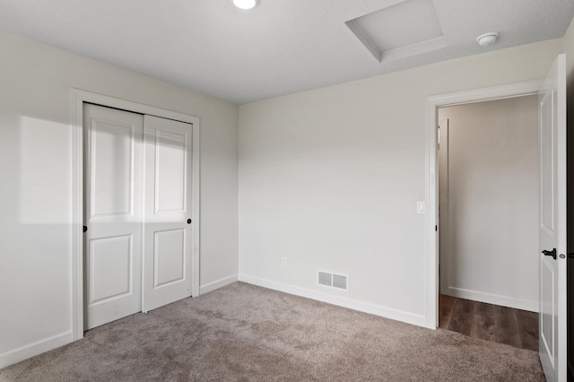 18872 Fillmore St NW, Elk River, MN 55330 - unfurnished bedroom with attic access, carpet, baseboards, and a closet