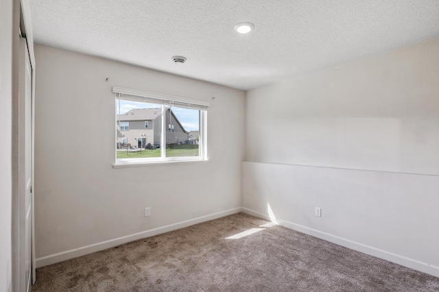 18872 Fillmore St NW, Elk River, MN 55330 - empty room featuring carpet, a textured ceiling, baseboards, and a smoke detector