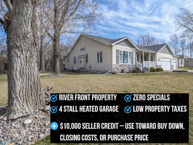 1311 Cossette Dr S, Fargo, ND 58104 - view of front of home with an attached garage, a front yard, a porch, and stone siding