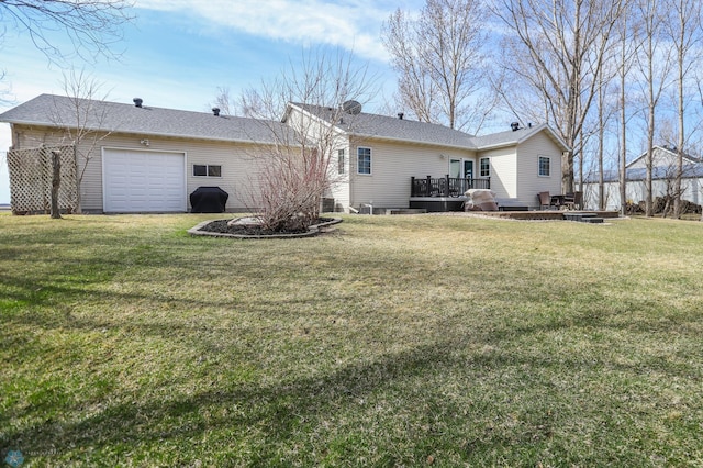 1311 Cossette Dr S, Fargo, ND 58104 - back of house featuring a wooden deck, a garage, and a yard