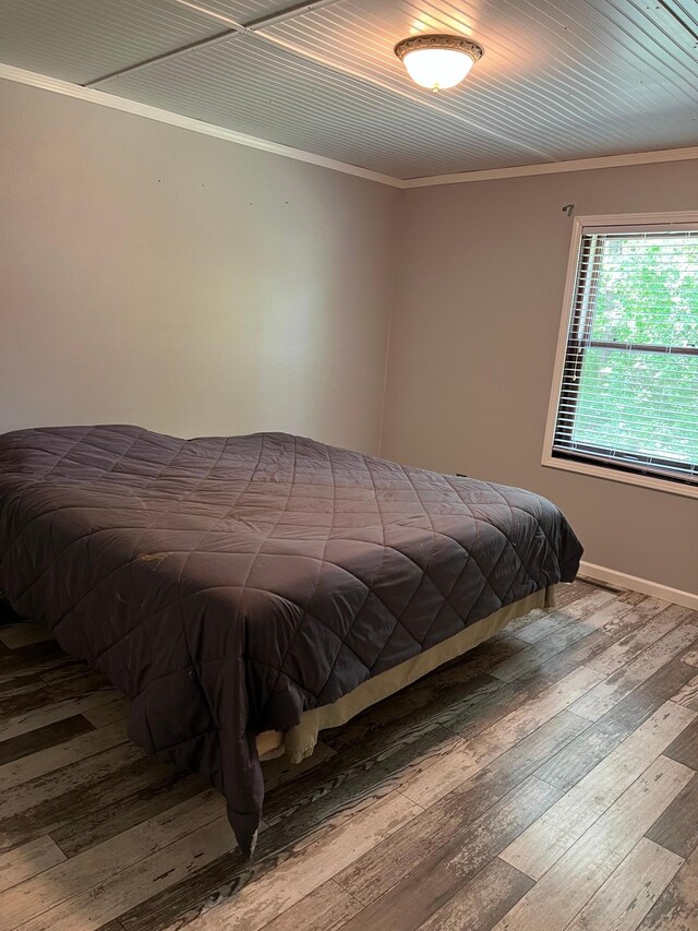 10624 56 1/2 St, Palmer Twp, MN 55319 - bedroom featuring ornamental molding, wood-type flooring, and baseboards