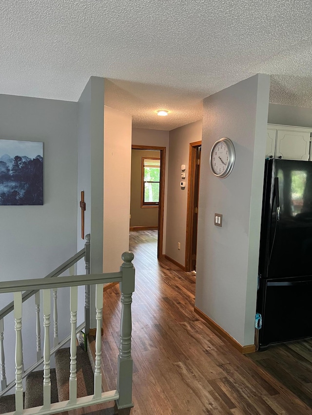 10624 56 1/2 St, Palmer Twp, MN 55319 - hall with a textured ceiling, an upstairs landing, dark wood finished floors, and baseboards