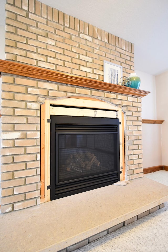 interior details featuring a fireplace and baseboards