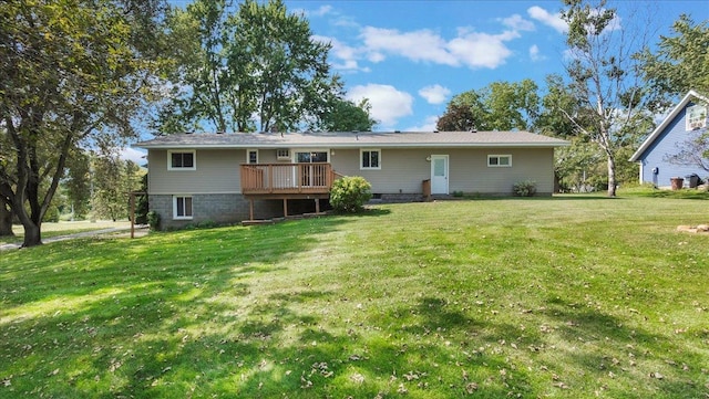 back of property featuring a deck and a lawn