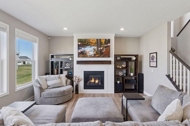 2141 Johanna Cir, Lino Lakes, MN 55038 - living room with stairway, a fireplace, recessed lighting, and wood finished floors
