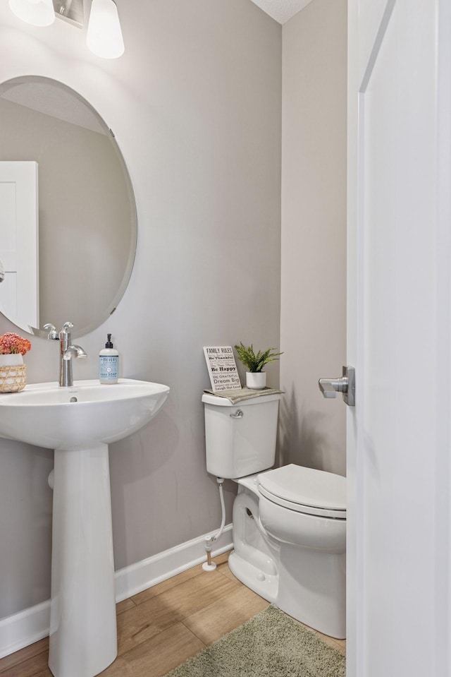 2141 Johanna Cir, Lino Lakes, MN 55038 - half bath featuring toilet, baseboards, a sink, and wood finished floors