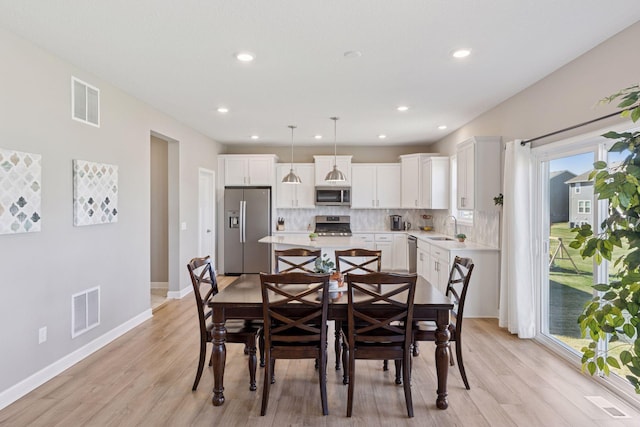 2141 Johanna Cir, Lino Lakes, MN 55038 - dining room featuring light wood-style floors, baseboards, and visible vents