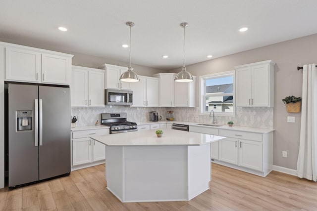 2141 Johanna Cir, Lino Lakes, MN 55038 - kitchen with a sink, white cabinets, light wood-style floors, and stainless steel appliances