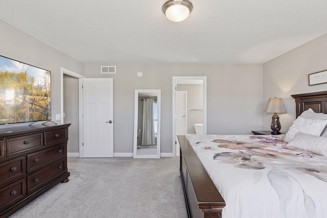 2141 Johanna Cir, Lino Lakes, MN 55038 - bedroom with a textured ceiling, light colored carpet, visible vents, baseboards, and ensuite bathroom