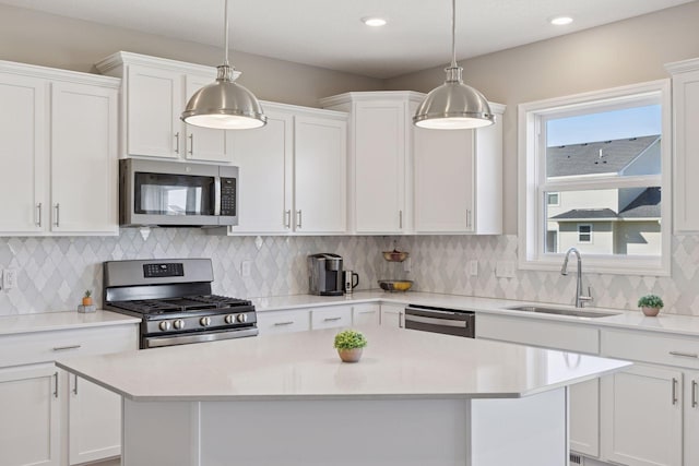 2141 Johanna Cir, Lino Lakes, MN 55038 - kitchen with a center island, light countertops, white cabinets, a sink, and appliances with stainless steel finishes
