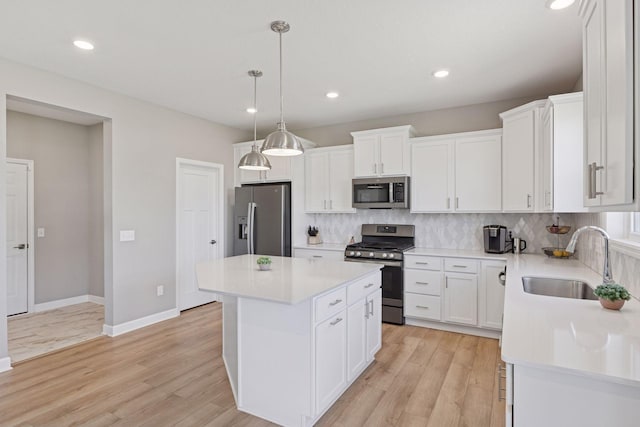 2141 Johanna Cir, Lino Lakes, MN 55038 - kitchen featuring decorative backsplash, a kitchen island, light countertops, a sink, and stainless steel appliances